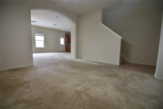 a view of a big room with stairs and a garage