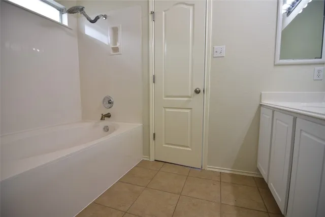 a bathroom with a granite countertop toilet a sink and a mirror