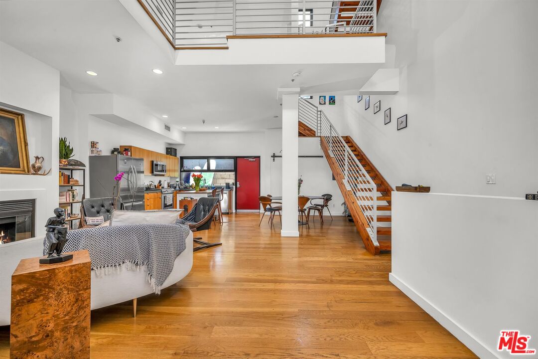 815 Hampton Drive, Unit 5B Venice, CA 90291 - Photo 2 of 20 a living room with fireplace furniture and a wooden floor