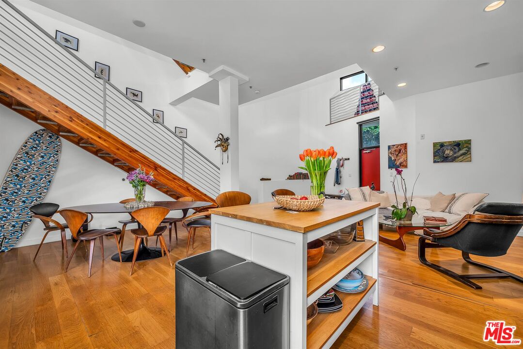 815 Hampton Drive, Unit 5B Venice, CA 90291 - Photo 6 of 20 a living room with furniture kitchen view and a wooden floor