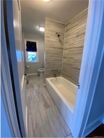 a bathroom with a tub a sink and a shower