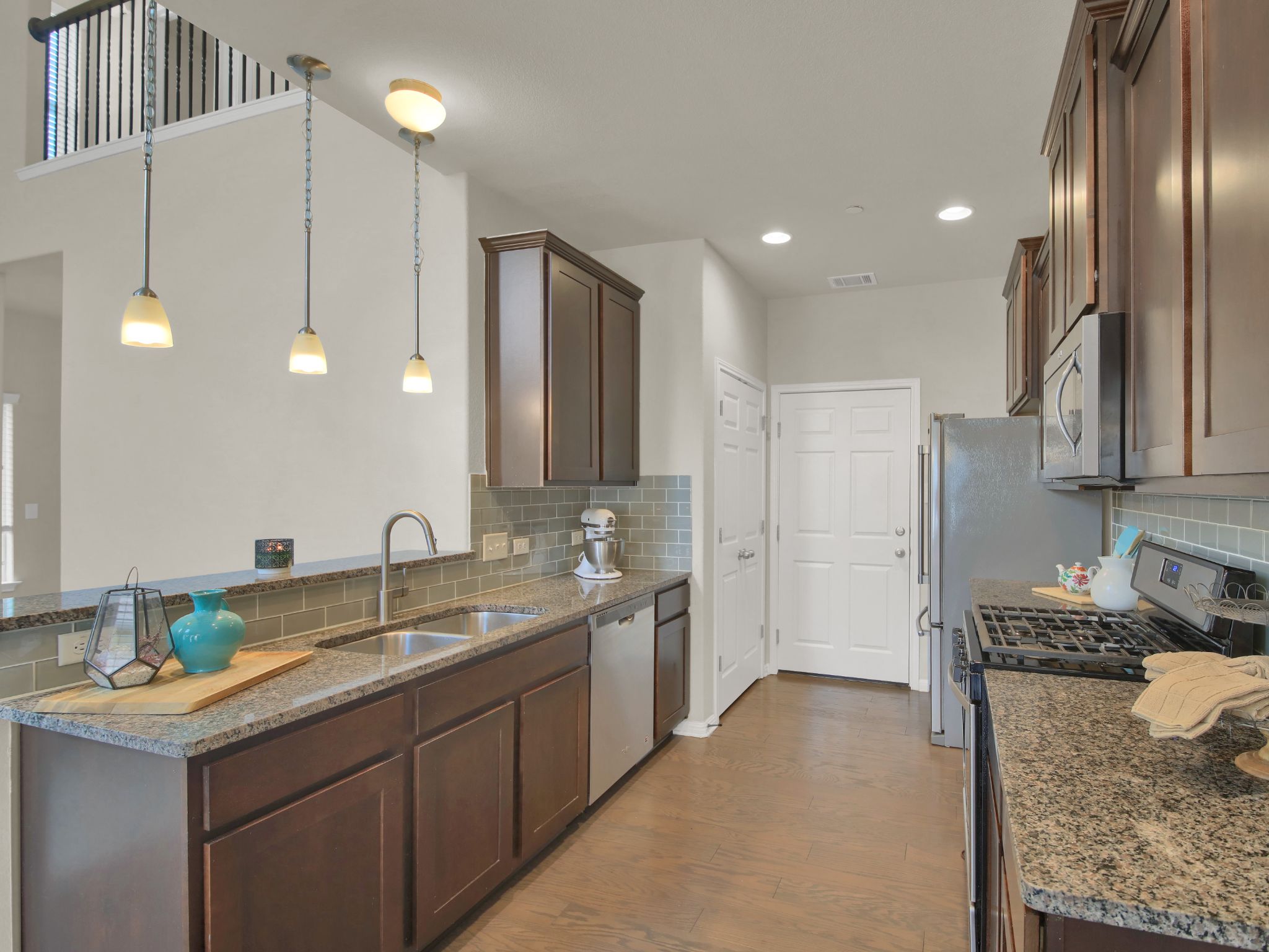 1600 Airedale Road, Unit 2601 Austin, TX 78748 - Photo 8 of 26 Culinary aspirations find their home in this well-appointed kitchen featuring rich wood cabinetry and ample counter space.