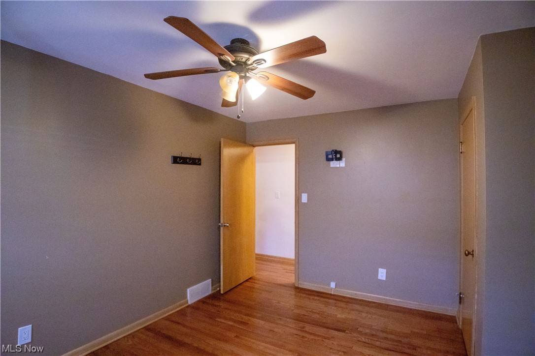 7674 Ragall Parkway Cleveland, OH 44130 - Photo 18 of 32 Wood floored spare room with ceiling fan