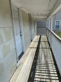 a view of balcony with wooden floor