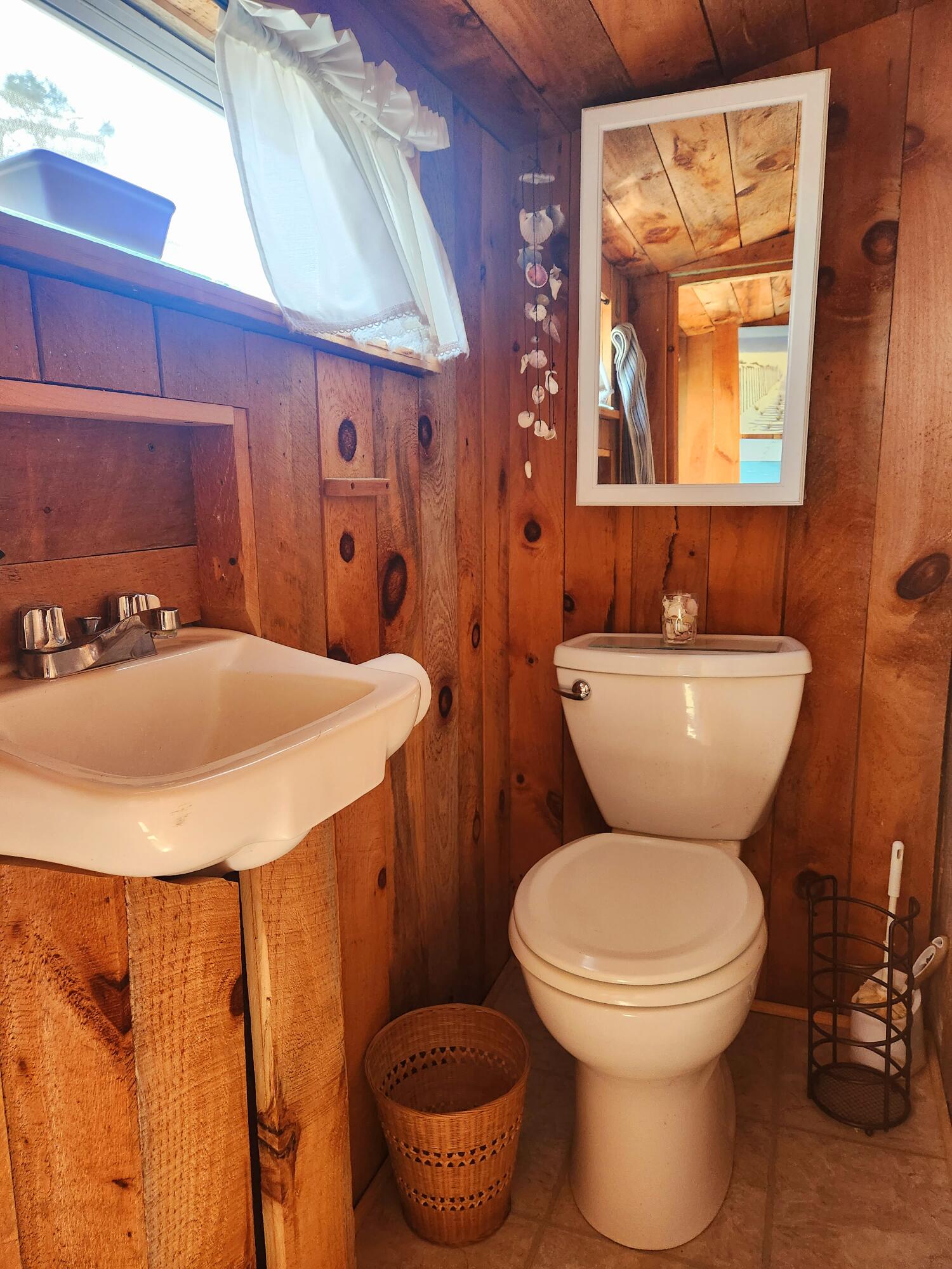 9 Windy Hill Road, Unit D Buzzards Bay, MA 02532 - Photo 11 of 15 a bathroom with a toilet sink and mirror