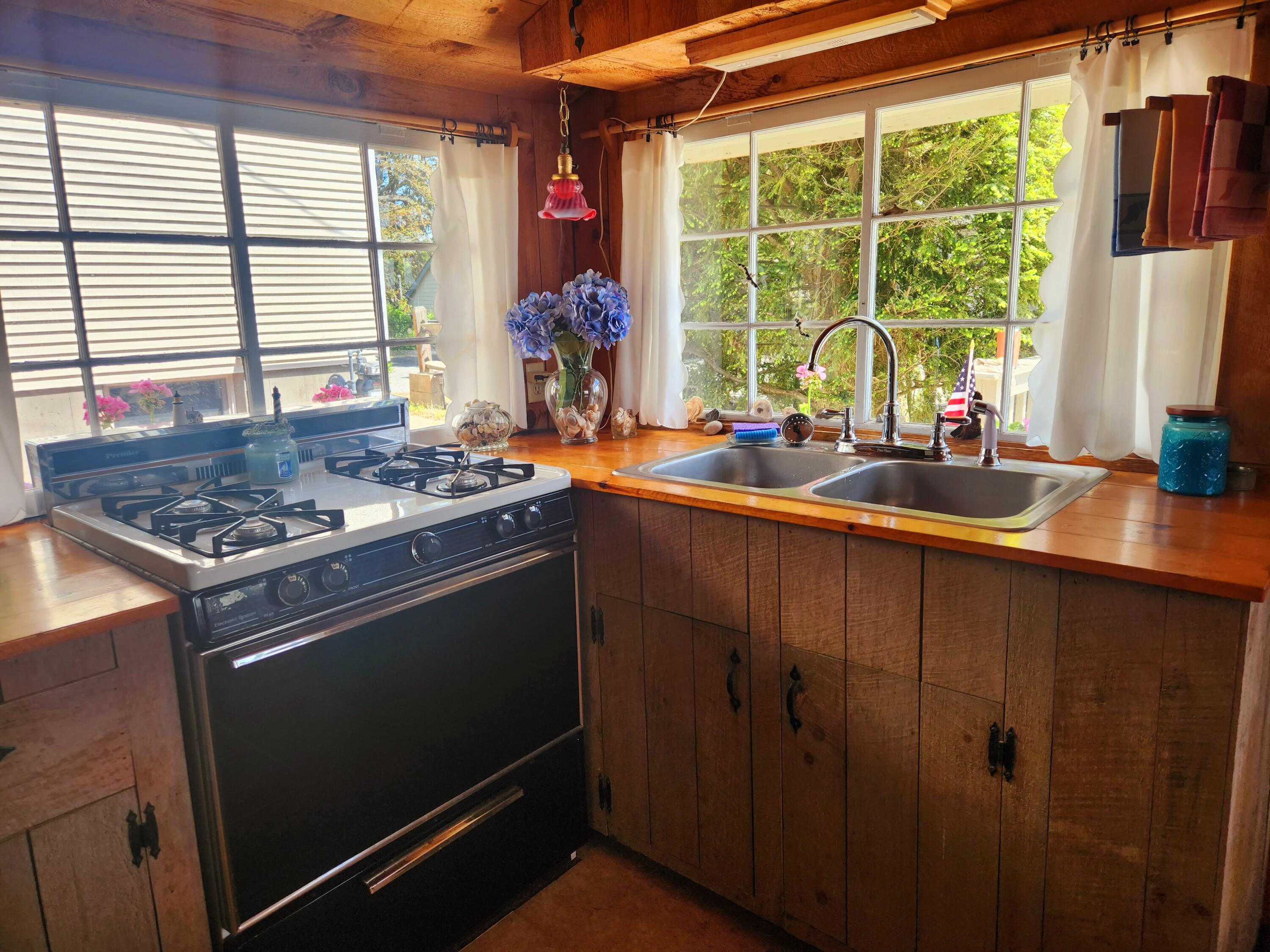 9 Windy Hill Road, Unit D Buzzards Bay, MA 02532 - Photo 6 of 15 a kitchen with stainless steel appliances a stove sink and window