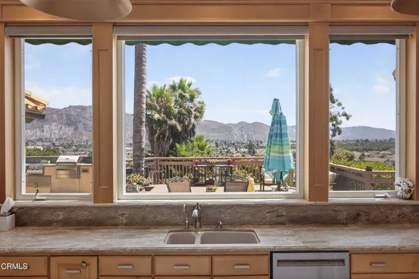 a view of a dining room with furniture large window and wooden floor