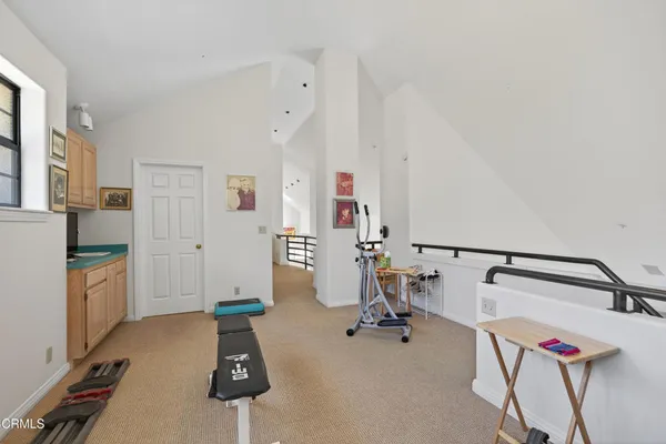 a view of a balcony with wooden floor and fence