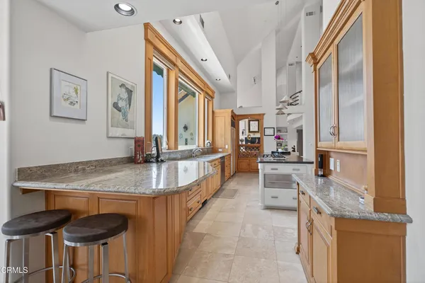 a kitchen with stainless steel appliances granite countertop a stove and a sink