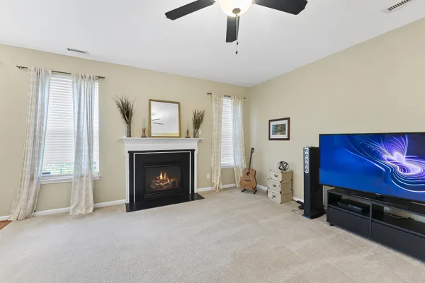 a view of an empty room with furniture and a fireplace