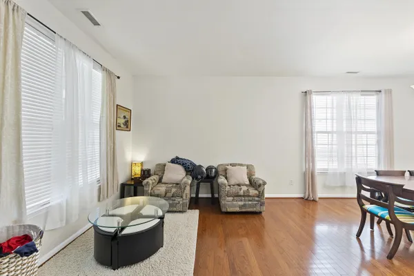 a living room with furniture and wooden floor