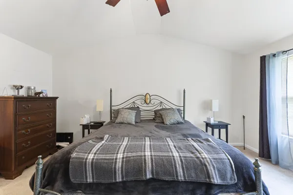 a bedroom with a bed and a dresser