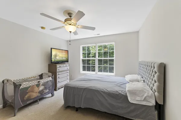 a bedroom with a bed couch and window