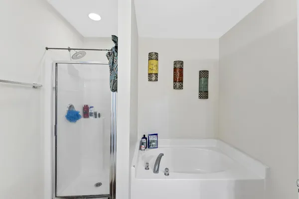 a white bath tub with a shower