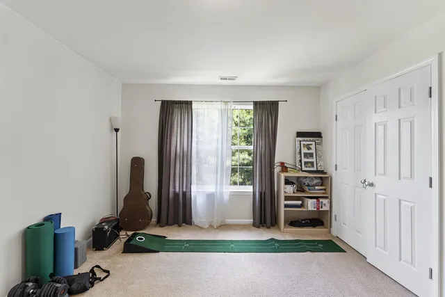 a view of room with window and refrigerator