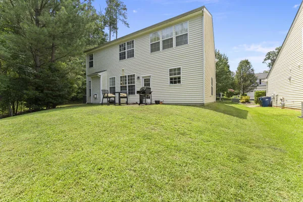 a view of a house with a yard and sitting area