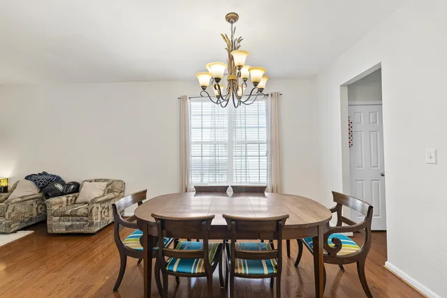 a view of a dining room with furniture and chandelier