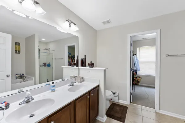 a bathroom with a sink double vanity and a mirror