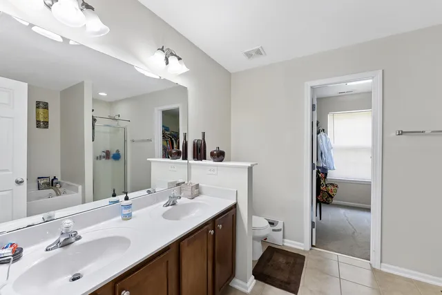 a bathroom with a sink double vanity and a mirror
