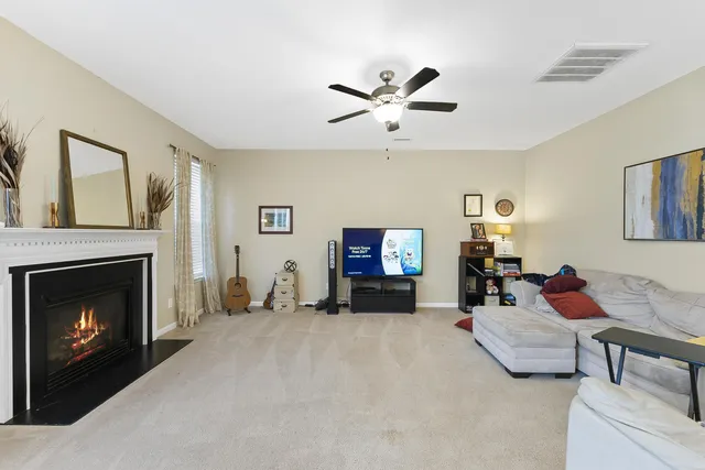a living room with furniture and a fireplace