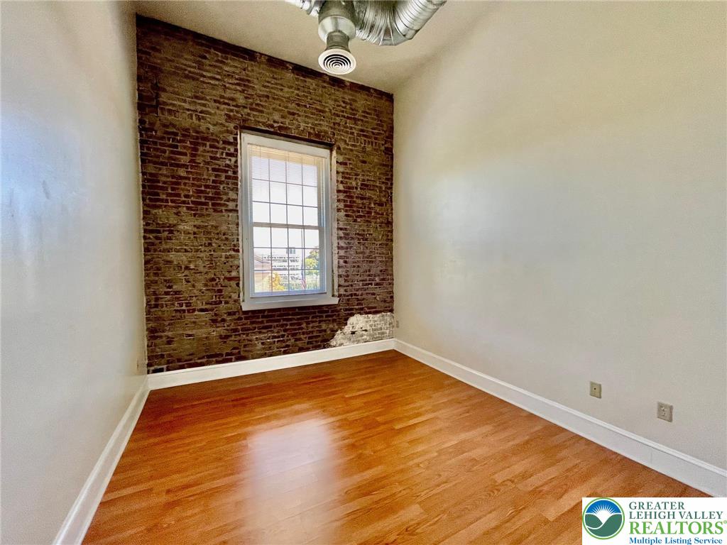 147 South 4th Street, Unit 17 Easton, PA 18042 - Photo 16 of 20 a view of an empty room with a window and wooden floor