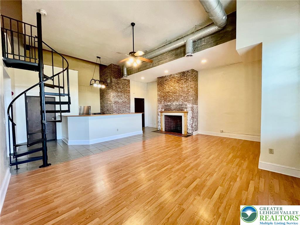 147 South 4th Street, Unit 17 Easton, PA 18042 - Photo 4 of 20 a view of a livingroom with wooden floor and a ceiling fan