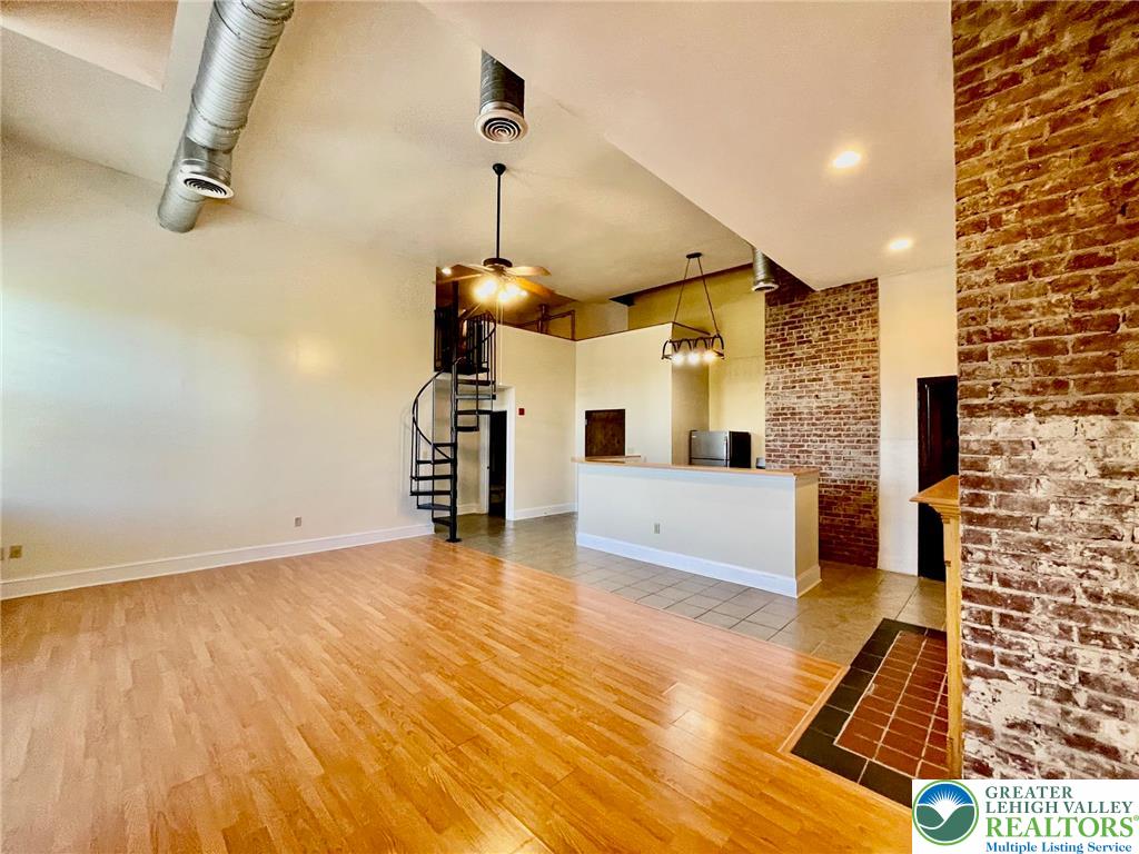 147 South 4th Street, Unit 17 Easton, PA 18042 - Photo 5 of 20 a view of a living room and kitchen with a wooden floor