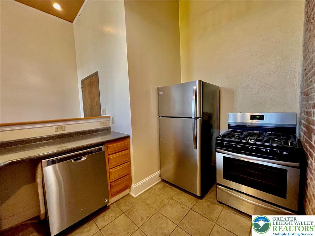147 South 4th Street, Unit 17 Easton, PA 18042 - Photo 8 of 20 a kitchen with a stove and a refrigerator with wooden floor