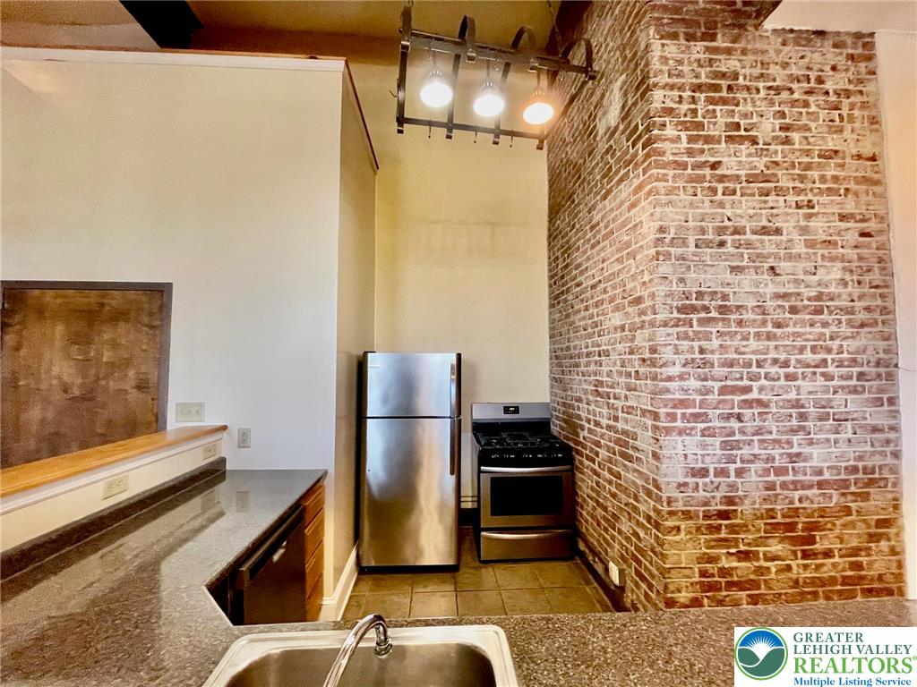 147 South 4th Street, Unit 17 Easton, PA 18042 - Photo 10 of 20 a kitchen with a refrigerator and a stove