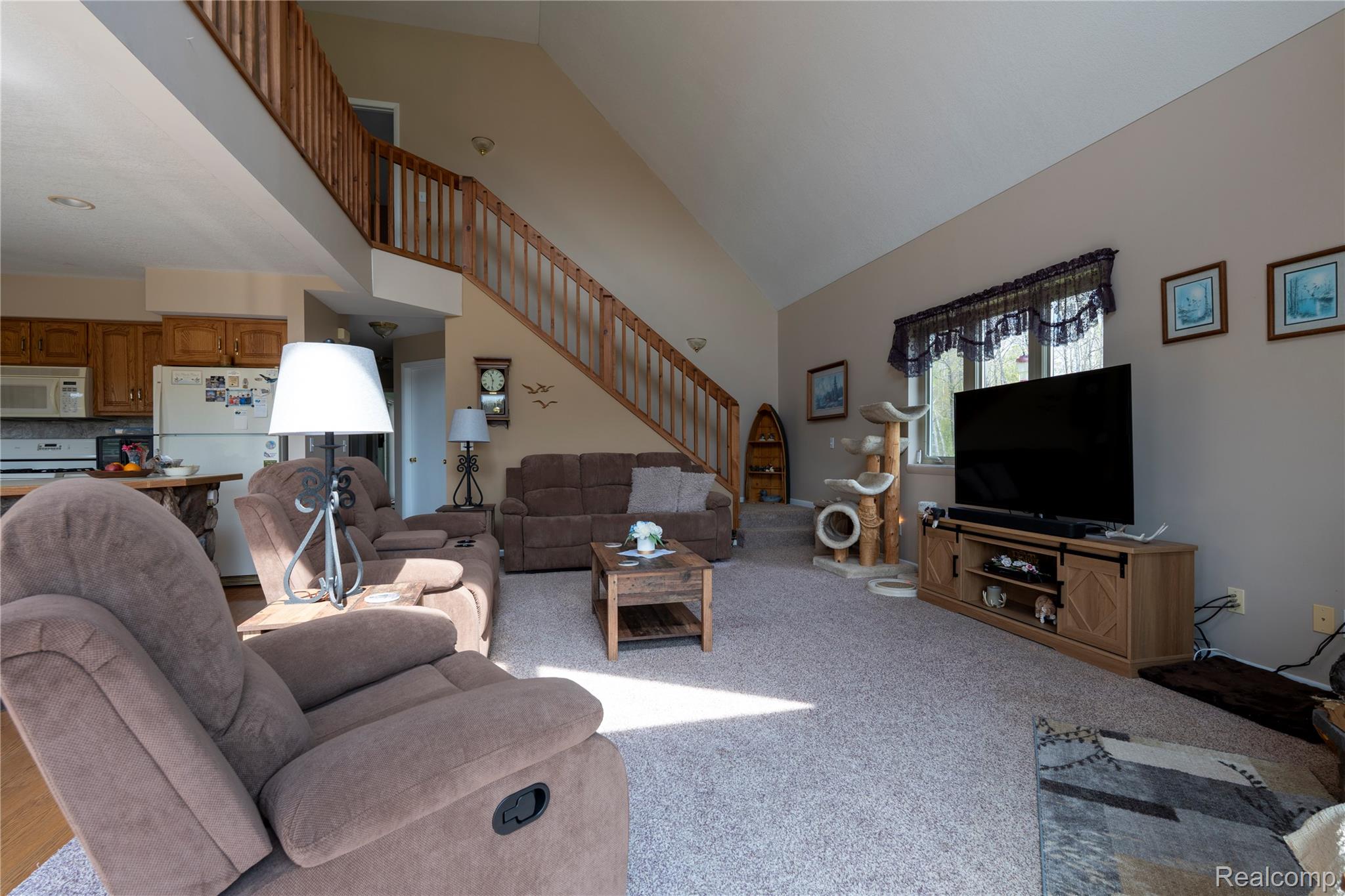 4180 Sage Lake Road Lupton, MI 48635 - Photo 8 of 40 Living area with light carpet and vaulted ceiling