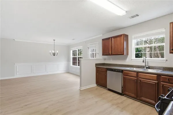 a kitchen with granite countertop a sink cabinets and window