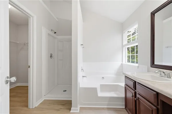 a bathroom with a tub shower and sink