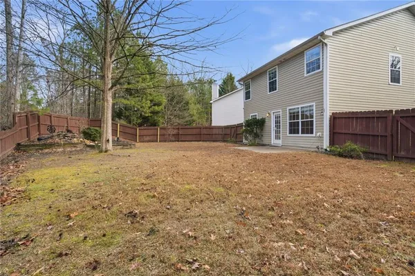 a backyard of a house with barbeque oven