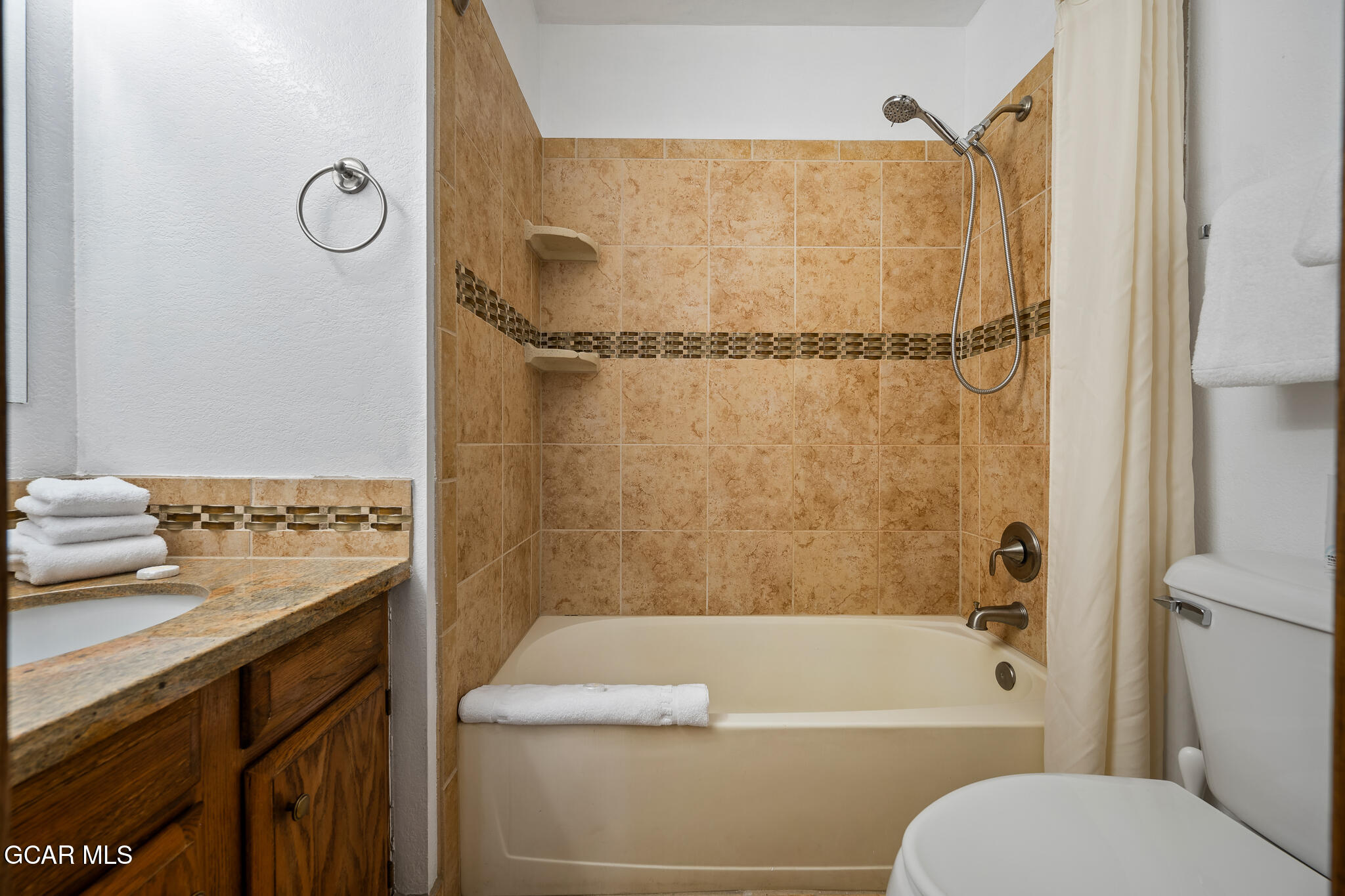 490 Kings Crossing Road, Unit 611 Winter Park, CO 80482 - Photo 31 of 39 a bathroom with a granite countertop bathtub shower sink vanity and toilet