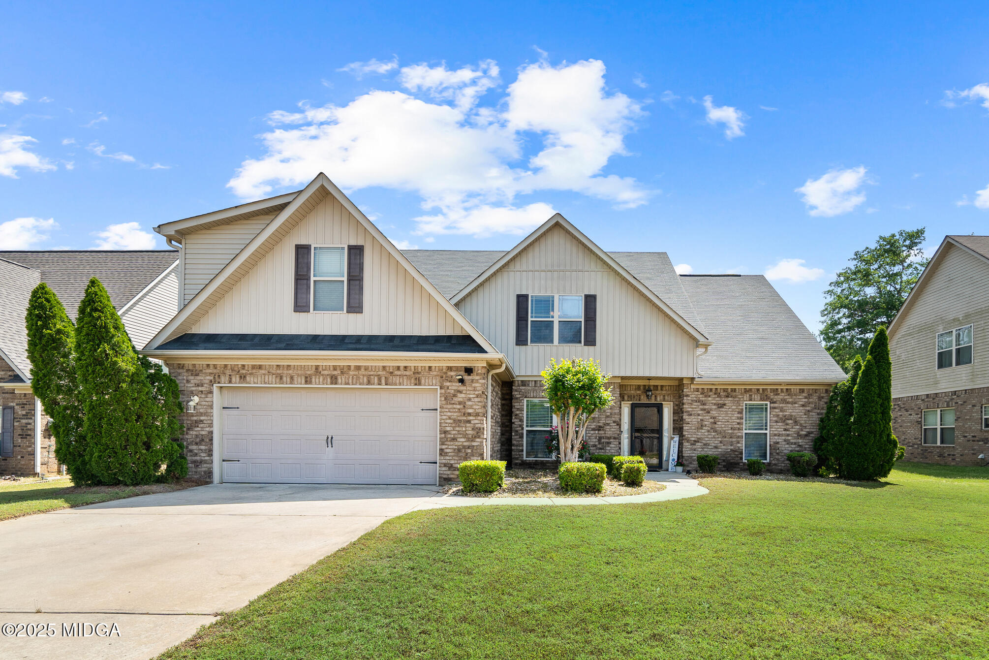 a front view of a house with a yard and garage