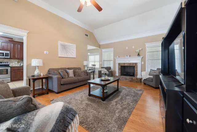 a living room with furniture flat screen tv and a fireplace