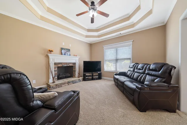 a living room with furniture and a fireplace