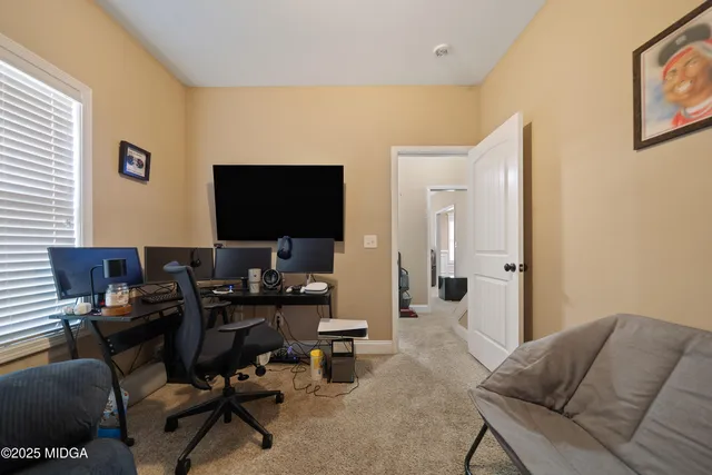 a livingroom with workspace and a couch