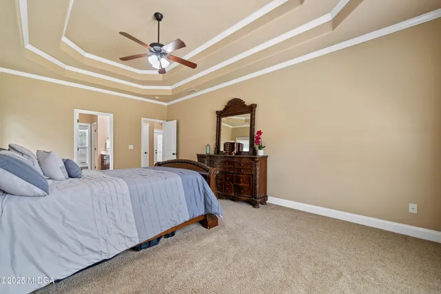 a bed room with a bed and a ceiling fan