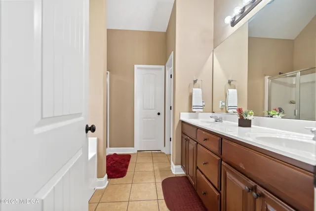 a spacious bathroom with a double vanity sink mirror and