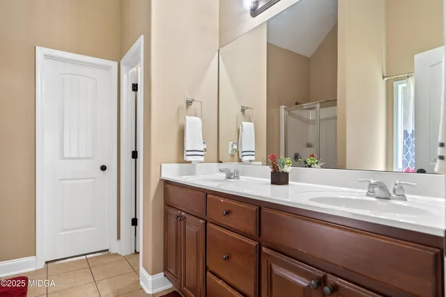 a bathroom with double vanity sinks and a mirror