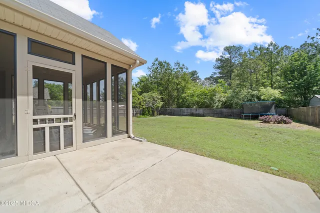 a view of a house with backyard and porch