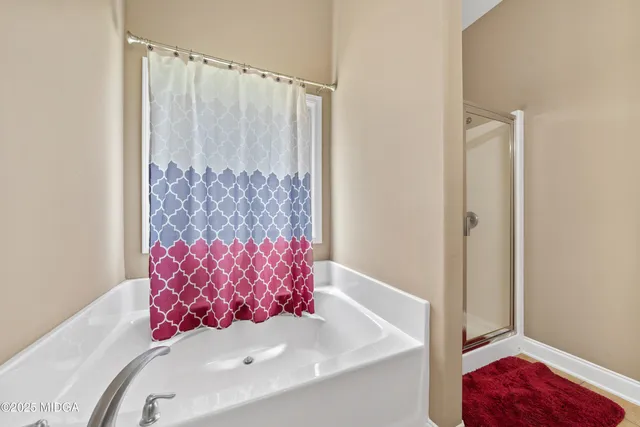 a bathroom with a tub shower and a sink