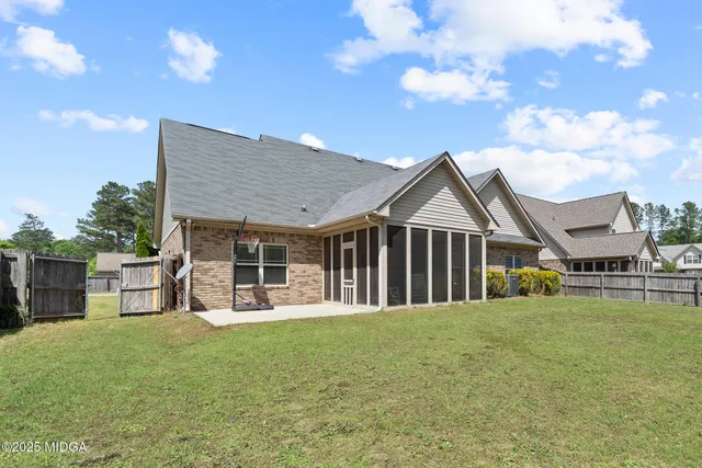 a view of a house with a yard and sitting area