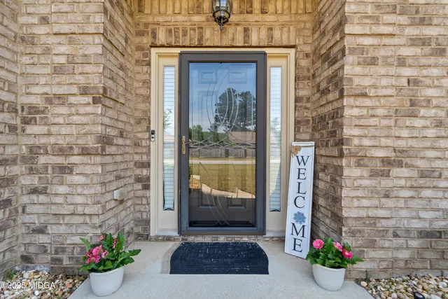 a view of front door of house with potted plant