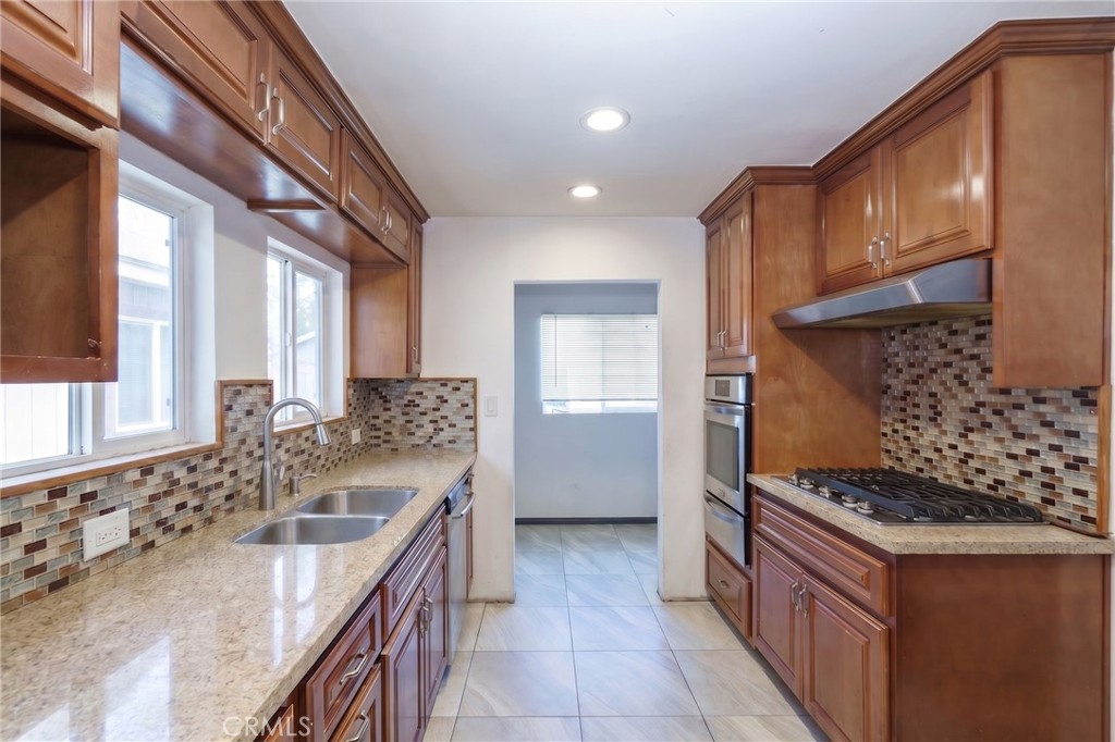 346 West School Street Compton, CA 90220 - Photo 16 of 29 a kitchen with a sink stove and cabinets