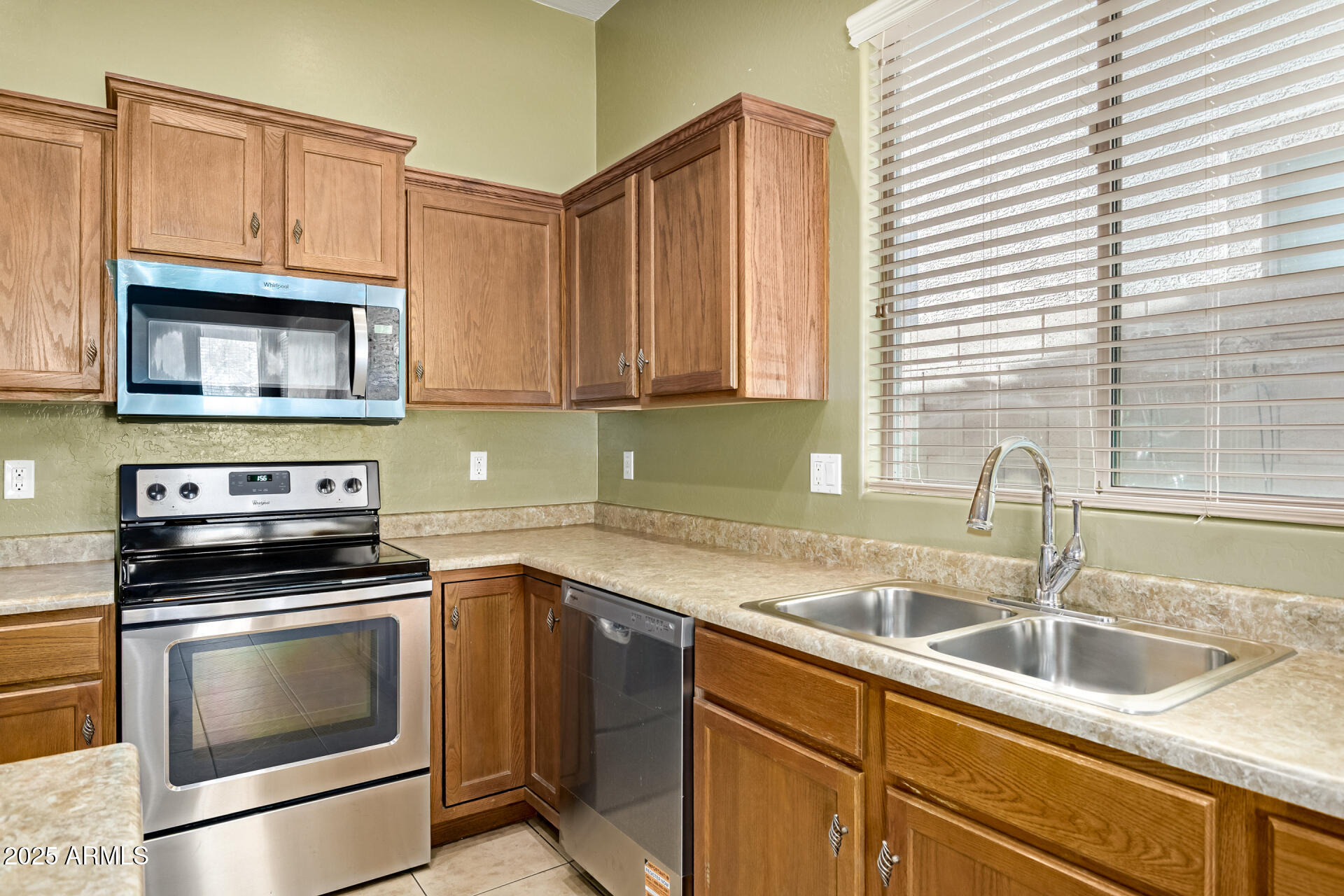 35819 North 33rd Lane Phoenix, AZ 85086 - Photo 15 of 50 a kitchen with granite countertop a sink a stove and cabinets