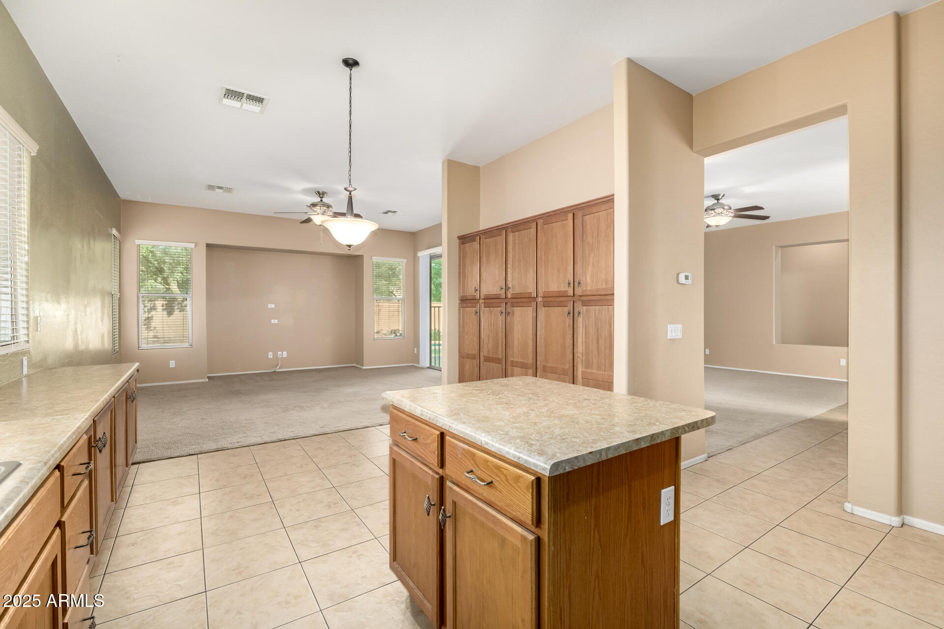 35819 North 33rd Lane Phoenix, AZ 85086 - Photo 16 of 50 a kitchen with a sink a refrigerator and chandelier