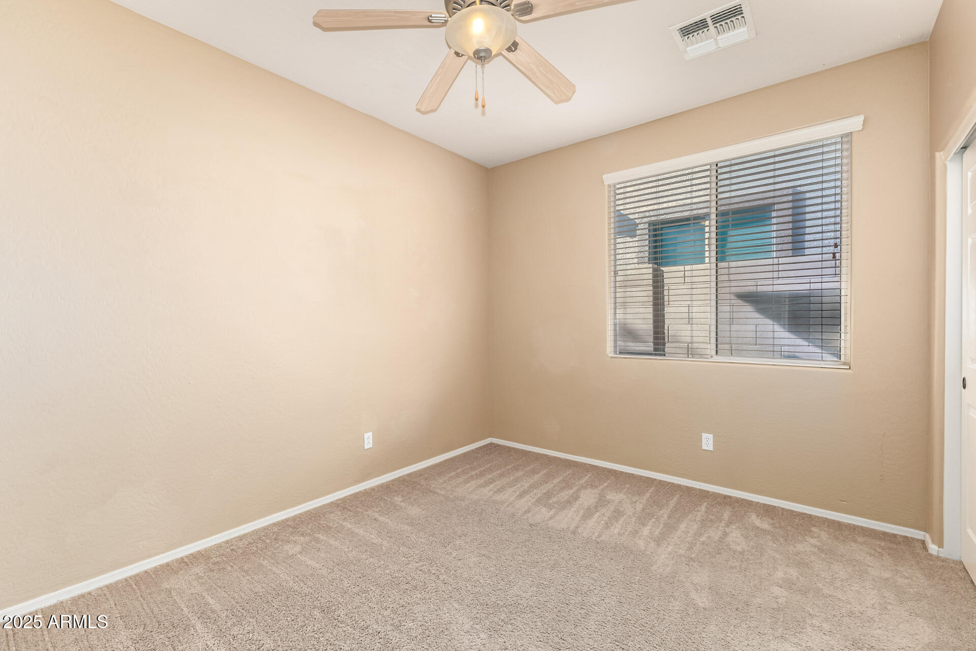 35819 North 33rd Lane Phoenix, AZ 85086 - Photo 27 of 50 an empty room with a window and a fan