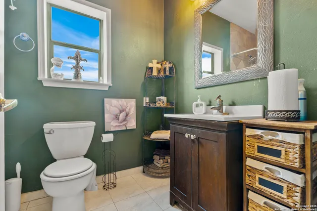a bathroom with a toilet a sink and mirror